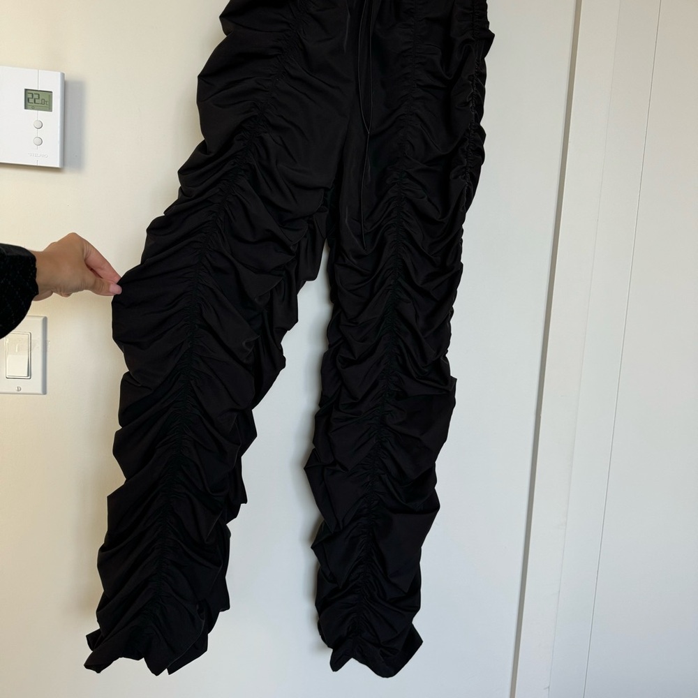 Parachute ruffle black pants in Medium